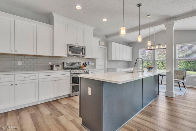 13196 Barrington Dr, Grafton, OH 44044 - kitchen with appliances with stainless steel finishes, light wood-style floors, decorative backsplash, light countertops, and recessed lighting