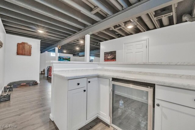 13196 Barrington Dr, Grafton, OH 44044 - indoor dry bar with beverage cooler and light wood finished floors