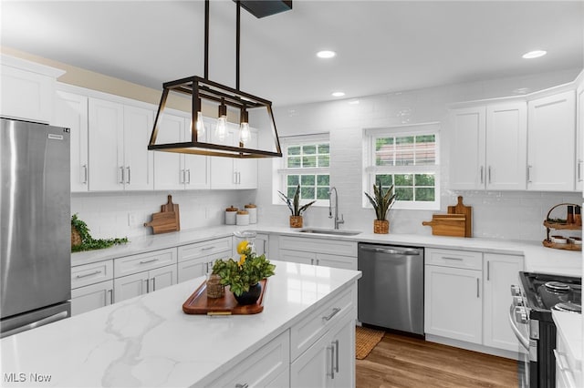 381 Lauretta Ln, Hubbard, OH 44425 - kitchen featuring appliances with stainless steel finishes, decorative backsplash, white cabinets, and recessed lighting