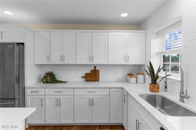 381 Lauretta Ln, Hubbard, OH 44425 - kitchen with freestanding refrigerator, white cabinets, decorative backsplash, light stone countertops, and recessed lighting