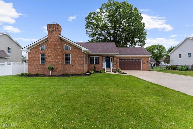 381 Lauretta Ln, Hubbard, OH 44425 - view of front of house with an attached garage, brick siding, driveway, and a chimney