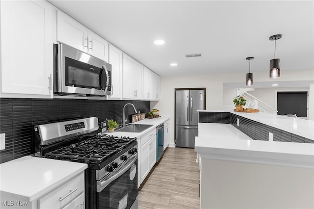 381 Lauretta Ln, Hubbard, OH 44425 - kitchen with stainless steel appliances, backsplash, light countertops, pendant lighting, and recessed lighting