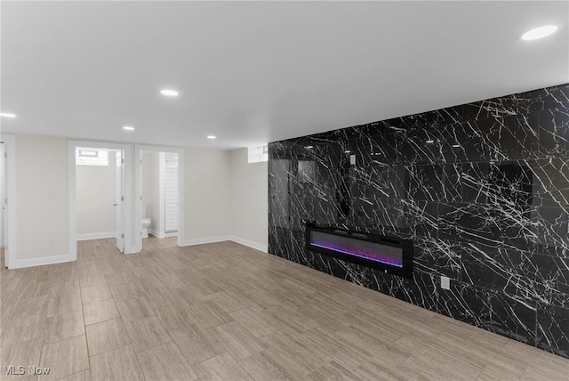 381 Lauretta Ln, Hubbard, OH 44425 - unfurnished living room featuring recessed lighting and a glass covered fireplace