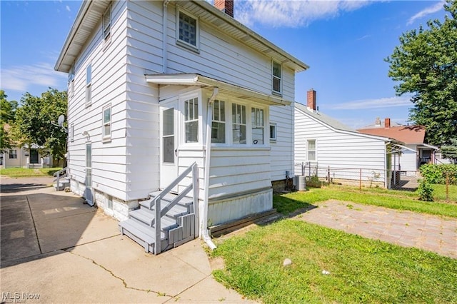 1145 Herberich Ave, Akron, OH 44301 - view of front of house with a chimney and entry steps