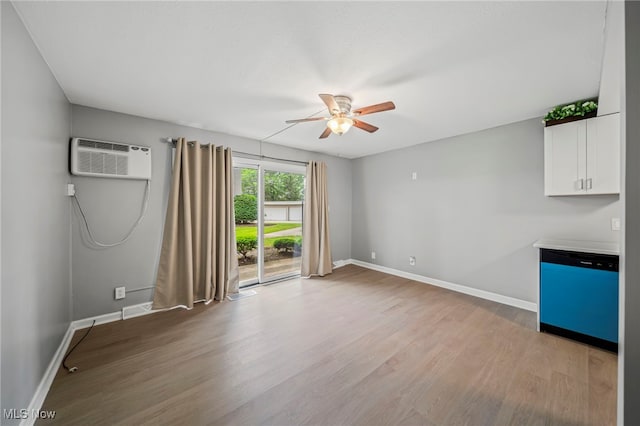 1372 Golden Gate Blvd, Mayfield Heights, OH 44124 - unfurnished living room with ceiling fan, light wood finished floors, and a wall mounted AC