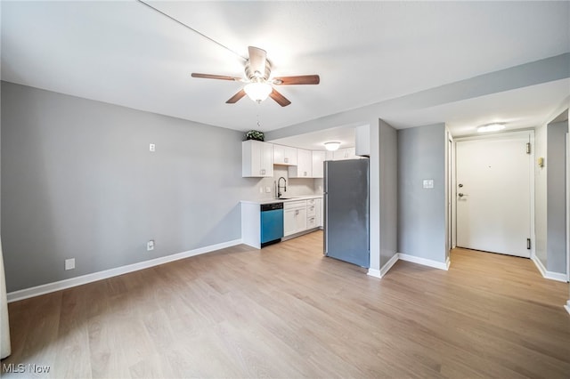 1372 Golden Gate Blvd, Mayfield Heights, OH 44124 - kitchen featuring freestanding refrigerator, dishwashing machine, ceiling fan, light countertops, and light wood finished floors