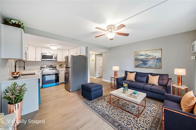 1372 Golden Gate Blvd, Mayfield Heights, OH 44124 - living area featuring a ceiling fan and light wood-style floors