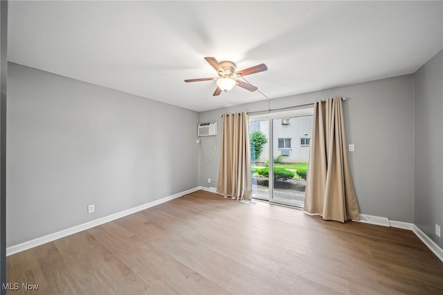 1372 Golden Gate Blvd, Mayfield Heights, OH 44124 - empty room featuring a ceiling fan, wood finished floors, and a wall unit AC
