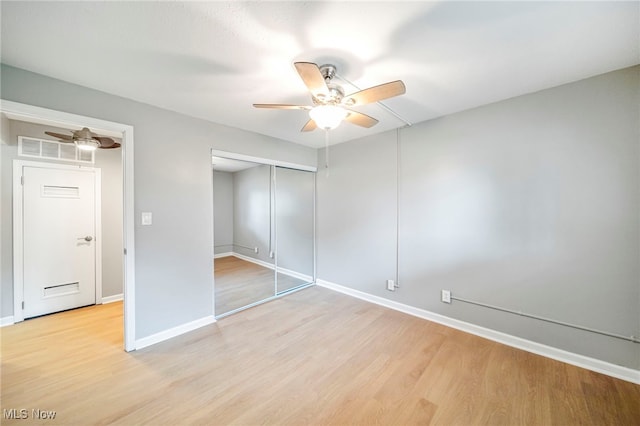 1372 Golden Gate Blvd, Mayfield Heights, OH 44124 - unfurnished bedroom with light wood-style floors, a closet, and ceiling fan