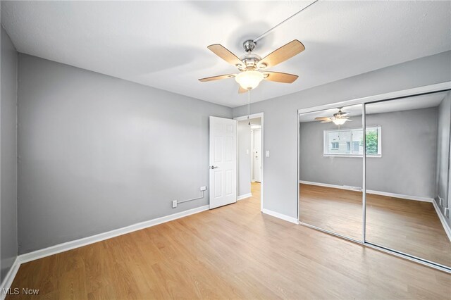 1372 Golden Gate Blvd, Mayfield Heights, OH 44124 - unfurnished bedroom with light wood-type flooring, a closet, and ceiling fan