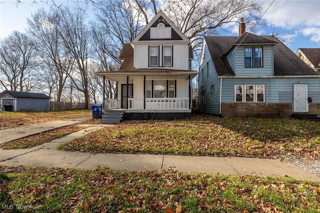 3888 W 37th St, Cleveland, OH 44109 - view of front facade with covered porch, a chimney, and stone siding