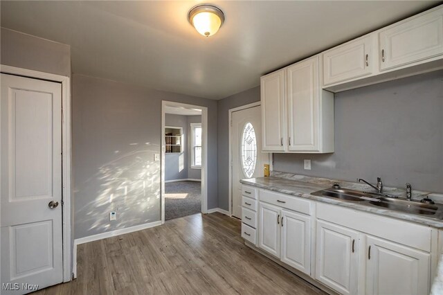 3888 W 37th St, Cleveland, OH 44109 - kitchen with light wood-type flooring, white cabinets, and light countertops