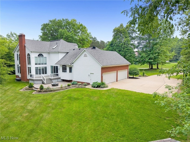 4035 Evergreen Ln, Richfield, OH 44286 - view of front of house with a chimney, a front yard, roof with shingles, a deck, and concrete driveway