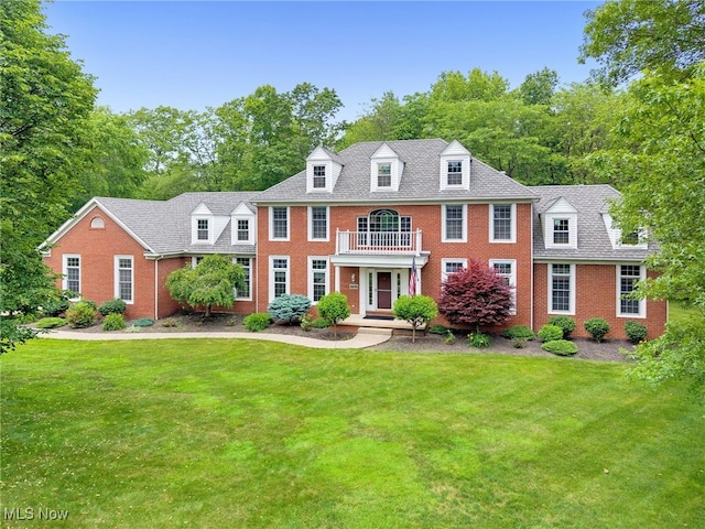 4035 Evergreen Ln, Richfield, OH 44286 - colonial house featuring a balcony, brick siding, and a front yard