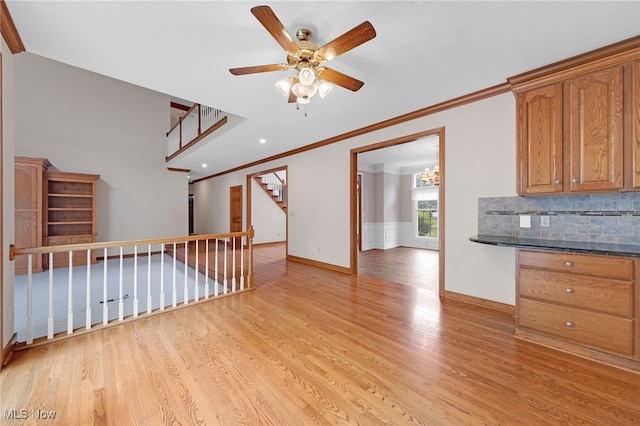 4035 Evergreen Ln, Richfield, OH 44286 - kitchen featuring light wood-style floors, crown molding, decorative backsplash, ceiling fan, and brown cabinets