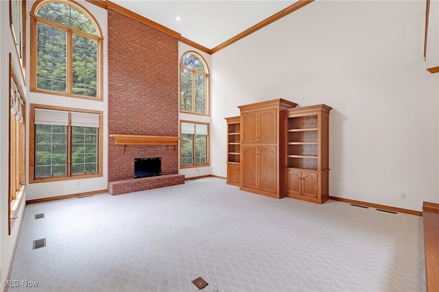4035 Evergreen Ln, Richfield, OH 44286 - unfurnished living room with a towering ceiling, light colored carpet, a fireplace, and crown molding