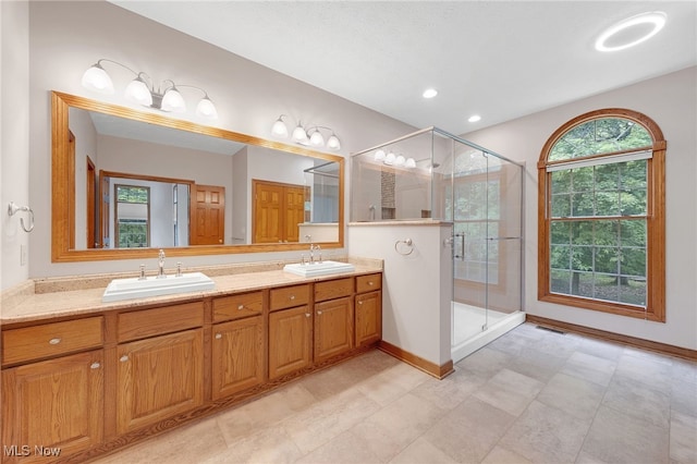 4035 Evergreen Ln, Richfield, OH 44286 - bathroom featuring double vanity, a stall shower, and recessed lighting