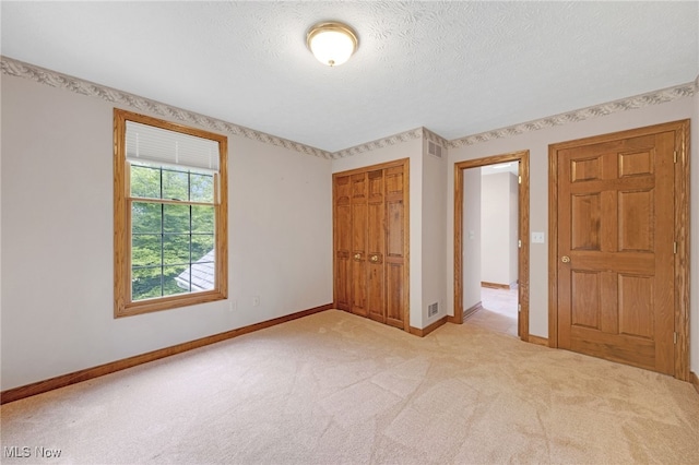 4035 Evergreen Ln, Richfield, OH 44286 - unfurnished bedroom with a closet, light carpet, and a textured ceiling