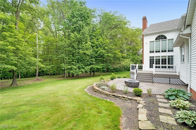4035 Evergreen Ln, Richfield, OH 44286 - view of grassy yard featuring a patio, an outdoor fire pit, and a wooden deck