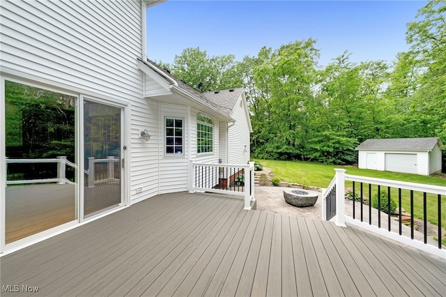 4035 Evergreen Ln, Richfield, OH 44286 - wooden deck with a fire pit, an outdoor structure, a yard, and a garage