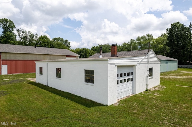 15459 Serfass Rd, Doylestown, OH 44230 - view of side of property featuring a chimney, a garage, a yard, and a shingled roof