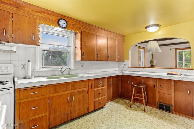 15459 Serfass Rd, Doylestown, OH 44230 - kitchen with white range with electric stovetop, under cabinet range hood, and brown cabinets