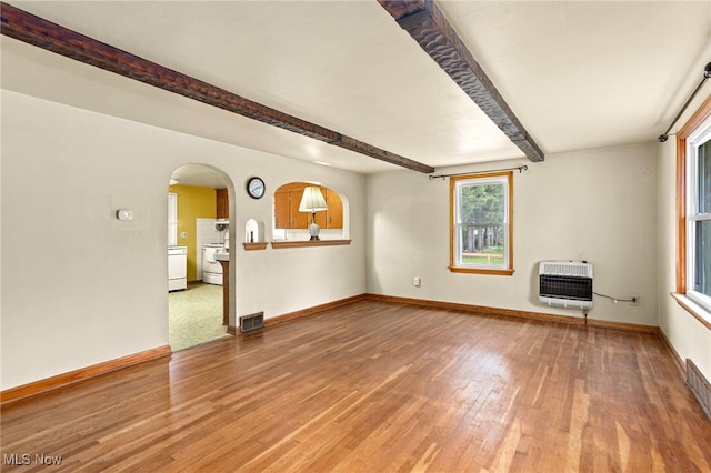 15459 Serfass Rd, Doylestown, OH 44230 - unfurnished living room featuring heating unit, wood finished floors, beamed ceiling, and arched walkways