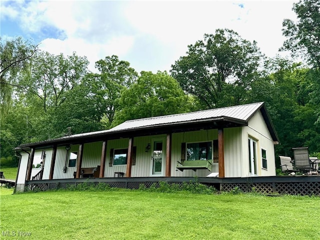 1550 Swift Rd, Waterford, OH 45786 - view of front facade with a porch, a front yard, a metal roof, and view of scattered trees