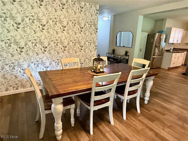 1550 Swift Rd, Waterford, OH 45786 - dining room featuring wallpapered walls and light wood finished floors