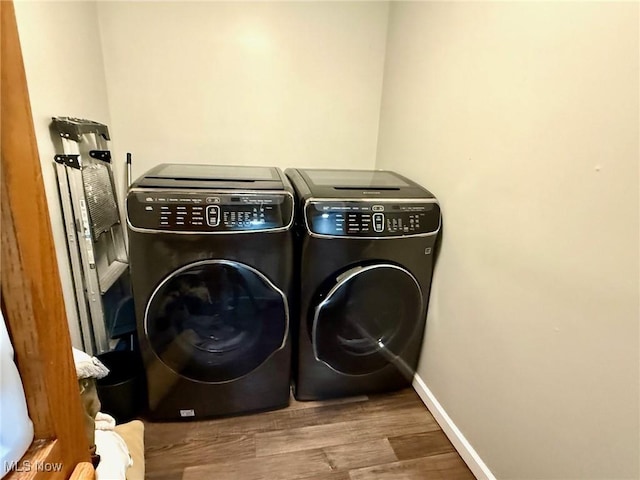 1550 Swift Rd, Waterford, OH 45786 - washroom with washer and clothes dryer and wood finished floors