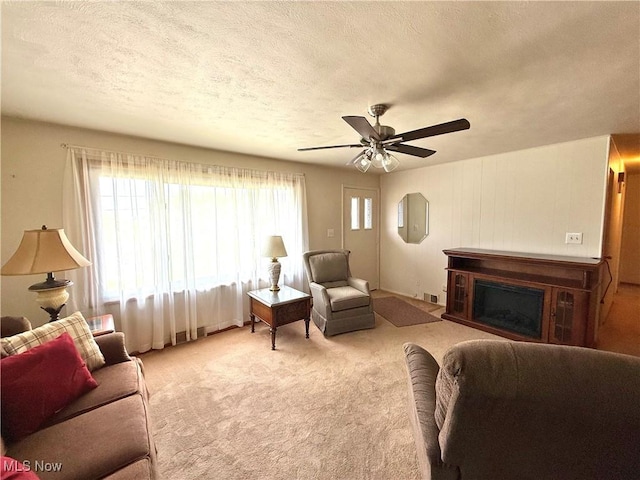 521 Blanar Ave, Weirton, WV 26062 - carpeted living room with a ceiling fan, a textured ceiling, and a fireplace