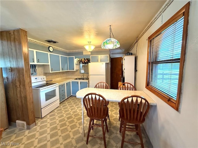 521 Blanar Ave, Weirton, WV 26062 - kitchen with white appliances, light countertops, a breakfast bar area, crown molding, and a peninsula