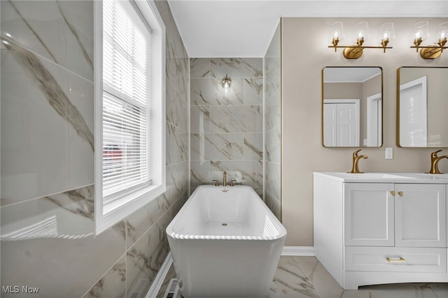 7569 Lake Shore Blvd, Madison, OH 44057 - full bath with double vanity, a soaking tub, marble finish flooring, and tile walls