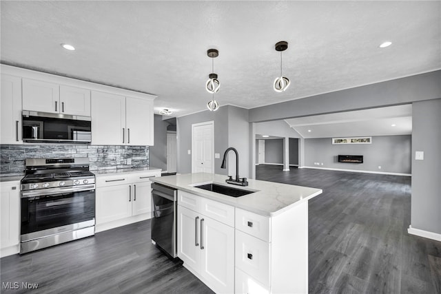 7569 Lake Shore Blvd, Madison, OH 44057 - kitchen with stainless steel appliances, decorative backsplash, dark wood-style flooring, pendant lighting, and recessed lighting