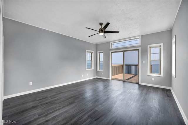 7569 Lake Shore Blvd, Madison, OH 44057 - unfurnished room featuring healthy amount of natural light, ceiling fan, dark wood-type flooring, and a textured ceiling