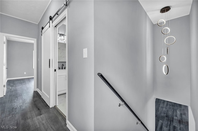 7569 Lake Shore Blvd, Madison, OH 44057 - hallway with an upstairs landing, dark wood-style floors, and a barn door