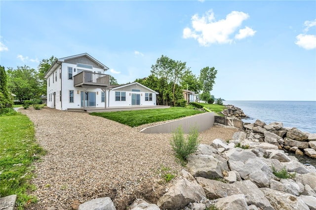 7569 Lake Shore Blvd, Madison, OH 44057 - view of side of home featuring a balcony, a water view, and a yard
