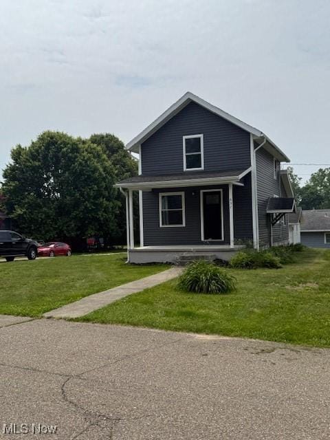 637 Maple St, Newcomerstown, OH 43832 - view of front facade with a porch and a front yard
