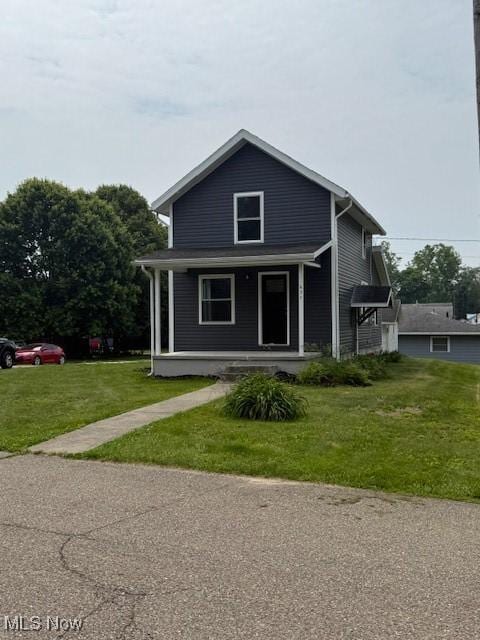 637 Maple St, Newcomerstown, OH 43832 - view of front of home with a porch and a front yard