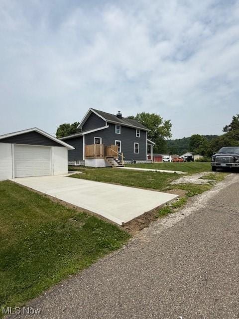 637 Maple St, Newcomerstown, OH 43832 - view of front of house with an outdoor structure, a front yard, and concrete driveway