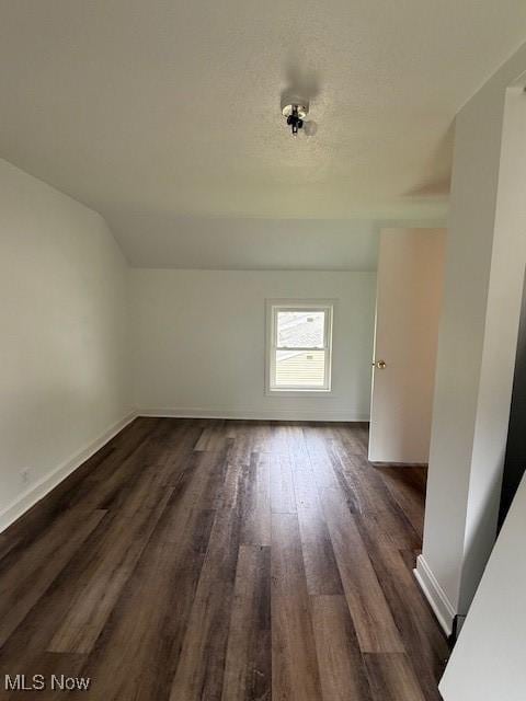 637 Maple St, Newcomerstown, OH 43832 - bonus room with dark wood-style floors and lofted ceiling