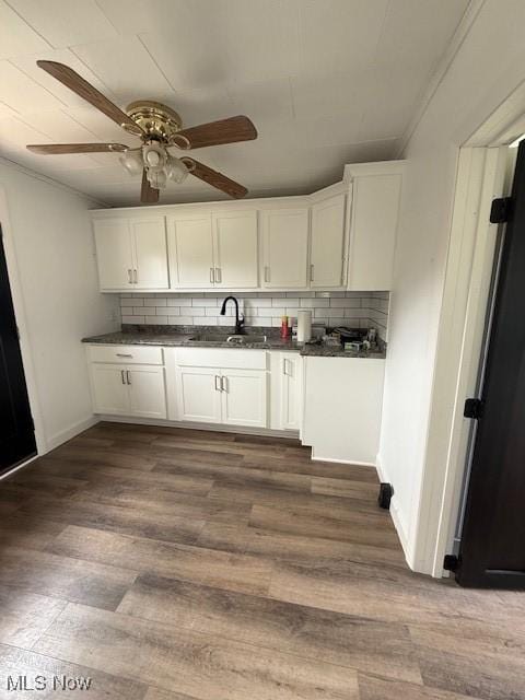 637 Maple St, Newcomerstown, OH 43832 - kitchen featuring backsplash, white cabinetry, and dark countertops