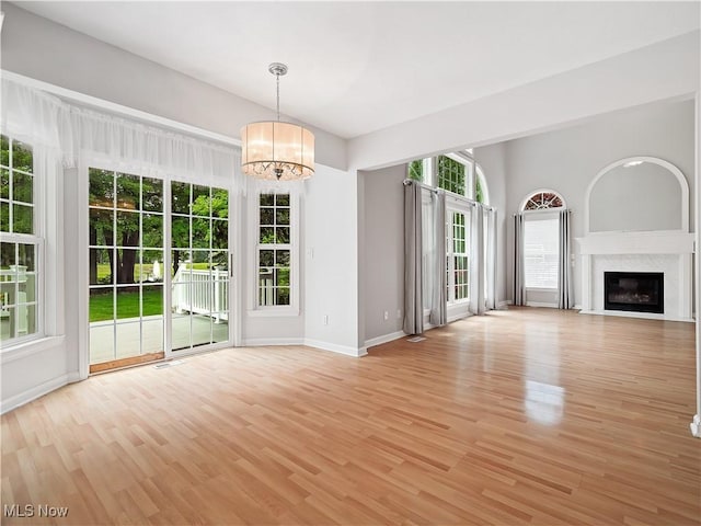 32969 Durrell Ave, Avon Lake, OH 44012 - unfurnished living room with a chandelier, light wood-type flooring, and a high end fireplace
