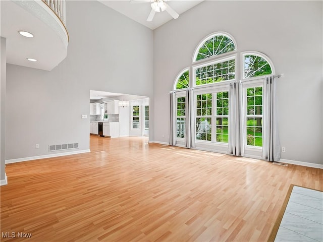 32969 Durrell Ave, Avon Lake, OH 44012 - unfurnished living room with high vaulted ceiling, a ceiling fan, and light wood-type flooring