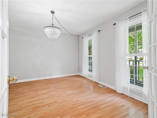 32969 Durrell Ave, Avon Lake, OH 44012 - unfurnished room featuring a chandelier and light wood-type flooring