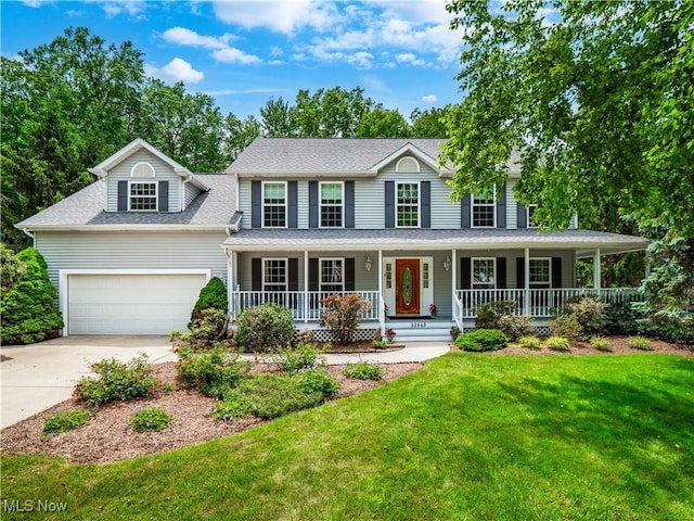 32969 Durrell Ave, Avon Lake, OH 44012 - colonial inspired home featuring concrete driveway, a porch, a front lawn, a garage, and a shingled roof