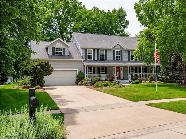 32969 Durrell Ave, Avon Lake, OH 44012 - view of front of home featuring covered porch, an attached garage, driveway, a front lawn, and roof with shingles