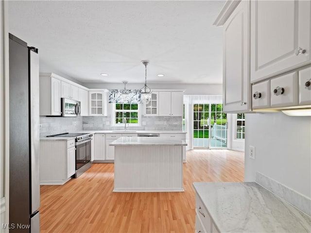 32969 Durrell Ave, Avon Lake, OH 44012 - kitchen with appliances with stainless steel finishes, light wood finished floors, healthy amount of natural light, tasteful backsplash, and recessed lighting