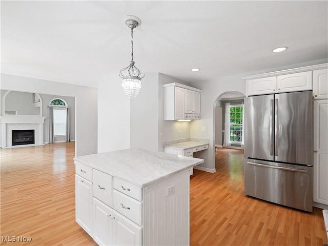32969 Durrell Ave, Avon Lake, OH 44012 - kitchen with freestanding refrigerator, arched walkways, light wood-type flooring, white cabinetry, and recessed lighting