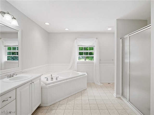 32969 Durrell Ave, Avon Lake, OH 44012 - bathroom featuring vanity, healthy amount of natural light, a wainscoted wall, a stall shower, and a garden tub